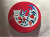 A professional product presentation of the authentic 4-piece printed ceramic folk cat coasters from a premier art, gift, and home decor supplier.