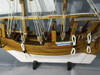 An 8-inch wooden dhow ship, perfectly sized for sophisticated home decor and maritime-themed displays.