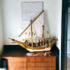 A stunning 15-inch masterpiece wooden dhow sculpture, meticulously hand-finished for an elite nautical display.