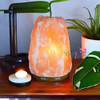 Natural Himalayan hand-carved salt lamp on a wooden base, authentic pink crystal rock light for home wellness