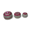A detailed view of the handcrafted round trinket containers, highlighting the intricate floral-like arrangements of pink gems and small pearls on the lids.