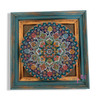 A stunning 25 cm handmade ceramic plate with multi-colored patterns set in a vintage-inspired frame for wall decor.