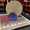 A stunning circular enameled copper plate displayed against a neutral background, highlighting its gift-ready finish.