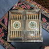 A 30x30 cm handmade wooden game set featuring a Khatamkari inlaid chessboard and a Tazhib painted interior.