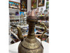 A professional product display shot of the vintage engraved brass pitcher designed for thematic hospitality and film environments.