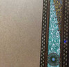 A professional product display shot of the 95x75 cm assorted pattern hand-painted Khatamkari frame positioned in an artisan workshop setting.