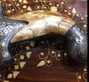 A 33 cm decorative Arabic dagger featuring a polished white camel bone handle and a traditional embossed metallic scabbard.