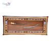 Full boardroom presentation of the elite bespoke Middle Eastern heritage sword frame styled elegantly on a gallery wall, serving as a prestigious VIP corporate gifting token or high-end diplomatic souvenir in Dubai.