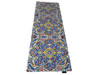 A 130x50 cm printed velvet table runner featuring a vibrant blue, yellow, and red mosaic tile floral pattern with a decorative vase on top.
