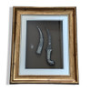Full setting presentation of the premium framed Middle Eastern heritage dagger styled on an upscale corporate majlis wall serving as an elite milestone token or VIP hospitality giveaway decoration in Dubai.