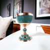 A professional product shot of the 44 cm turquoise and copper goblet displayed on a clean white tabletop surface.