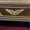 ceremonial golden sword hilt and guard, showcasing complex cultural engravings and high-luster metallic finishes.