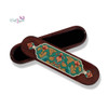Top-down close-up of the traditional motifs meticulously painted onto a multi-use wooden keepsake box, highlighting the fine line details and geometric precision.