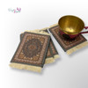 A professional product shot of the set of 4 assorted Persian rug coasters arranged neatly on a distressed wooden table.
