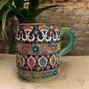 A professional product presentation of the exclusive hand-painted ceramic mug from a premier UAE shop.