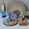 A professional product display shot of the 16 cm blue and orange floral Minakari copper plate positioned against a textured rustic background.