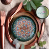 Detailed close-up of the intricate hand-painted floral motifs and high-shine glazed finish on a luxury Turkish ceramic plate.