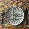 Detailed close-up of the complex glaze lines and brilliant mineral color fields on a hand-painted 30cm Moroccan serving dish.