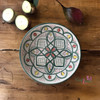 A traditional style large 30 cm Moroccan pottery plate mounted beautifully as an architectural wall art centerpiece in a luxury lounge.