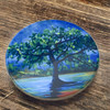 The 9-10 cm round printed coaster displayed on a natural surface, emphasizing its compact size and high-quality printed artistry.