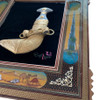 A 65x55 cm framed traditional Arabic dagger wall art piece featuring a hand-painted wooden frame displayed on a neutral wall above a marble console.