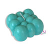 A professional product shot of the teal blue bubble cube candle displayed elegantly as a modern interior decor piece.
