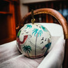 Assorted 3-inch paper mache ornaments with vibrant, unique hand-painted details.