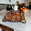 Ornate metal tea set used for traditional Turkish tea service on a copper tray