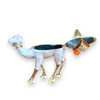 A stylish tabletop display of the jeweled white and gold camel figurine resting on a rustic wooden surface.
