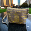 An exclusive Craftihouse decorative travel purse showcasing stylish gold Dubai lettering and a wrist strap.