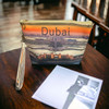 A stylish cosmetic and travel pouch adorned with a colorful Dubai landscape design.