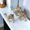 Elegant miniature camel family set, representing traditional UAE heritage with a luxurious, sparkling finish.