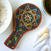 "The Culinary Canvas" ceramic spoon rest shown as a prestigious decorative accessory on a modern luxury marble kitchen counter in Dubai.