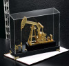 An exclusive Craftihouse premium corporate gift showcasing a polished gold-finish pumpjack model for energy sector executives.