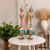 An elegantly arranged pair of copper pitchers with lids, highlighting the contrast between the reflective polished copper and the colorful Minakari enamel.