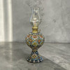 A 30 cm vintage-style hand-enamel painted earthenware kerosene lamp with vibrant, assorted artisan patterns.