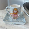 A professional product presentation of the exclusive hand-painted ceramic winter mug set from a premier UAE gift shop.
