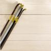 Angled perspective of the polished, flexible wooden shafts, emphasizing the sleek lightweight craftsmanship required for traditional folk choreography and formal events.
