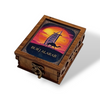 Close-up of a handcrafted wooden box showcasing intricate side carvings and a "Burj Al Arab" thematic lid design.