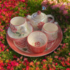 Elegant tea serving set with red rose pattern arranged on a tray, perfect for afternoon tea sessions