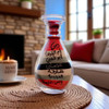 A 10 cm handcrafted glass bottle containing sand art from all 7 Emirates of the UAE.