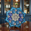 A professional product shot of the 16 cm copper Minakari plate displayed on a wooden tabletop surface.