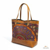 A classic brown leather handbag featuring a warm-toned, hand-embroidered Pateh Dozi panel with traditional Kerman motifs