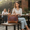 A boho-chic brown leather tote bag decorated with traditional Persian folk art embroidery, perfect for unique ethnic fashion lovers.