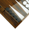 Close-up of the open backgammon board showing the mirror-like playing surface and sharp geometric points.