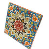 Detailed View Of A Geometric Star-Shaped Embossed Pattern On A Vibrant Yellow And Blue Artisanal Clay Tile.
