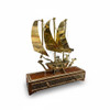 A handmade solid brass dhow sculpture mounted on a 30x8x5 cm wooden base with intricate Khatamkari geometric inlay.