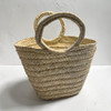 A large hand-woven natural palm leaf storage basket with two sturdy braided handles