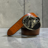 A premium handmade natural leather belt in a rich tan color featuring a silver-colored buckle with an embossed horse motif.