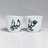 The Golden Diwan" personalized Ghawa cup shown as a prestigious accessory during a traditional coffee service in a Dubai Majlis.
